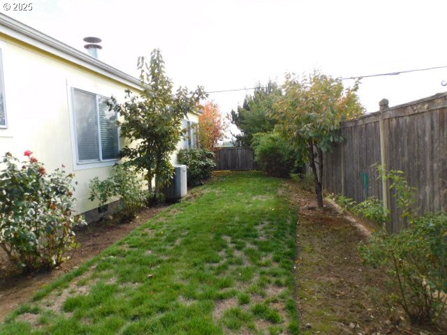 145 River Road Junction City, OR 97448 - Photo 2 of 35 a view of a backyard with plants and large trees