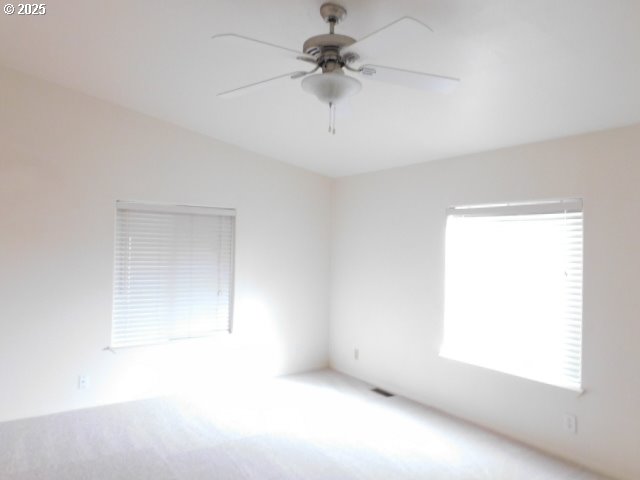 145 River Road Junction City, OR 97448 - Photo 30 of 35 an empty room with a window and a ceiling fan