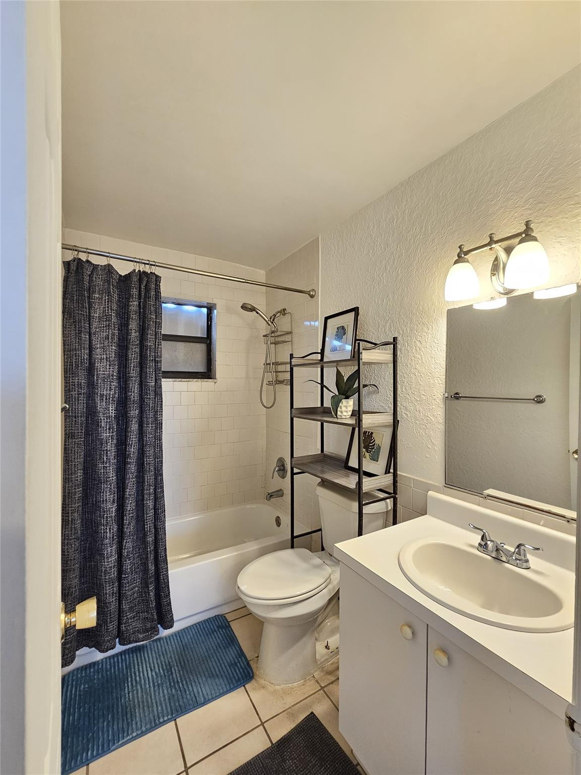 1021 Southeast Monterey Road, Unit 139 Stuart, FL 34994 - Photo 4 of 9 a bathroom with a sink toilet and shower