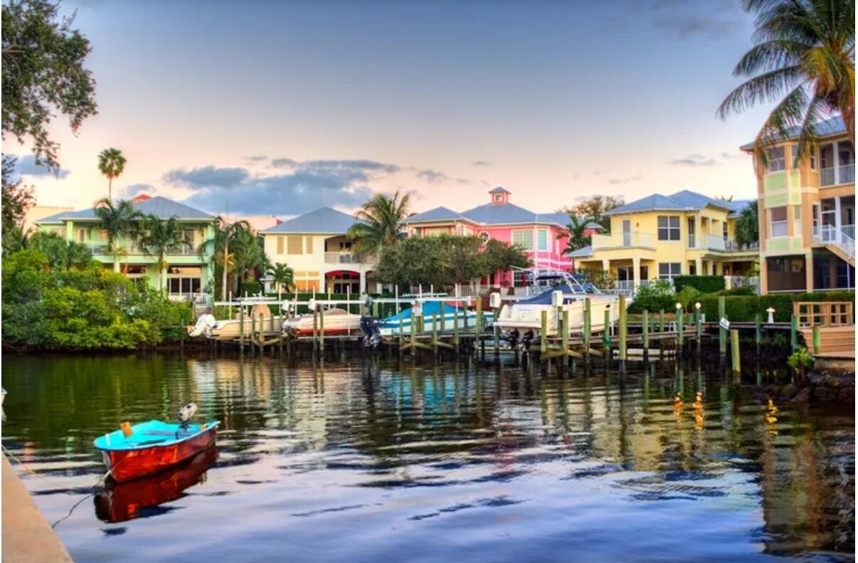 1021 Southeast Monterey Road, Unit 139 Stuart, FL 34994 - Photo 10 of 13 a lake with boats and trees in the background