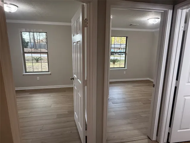 a bathroom with a glass door shower and a window