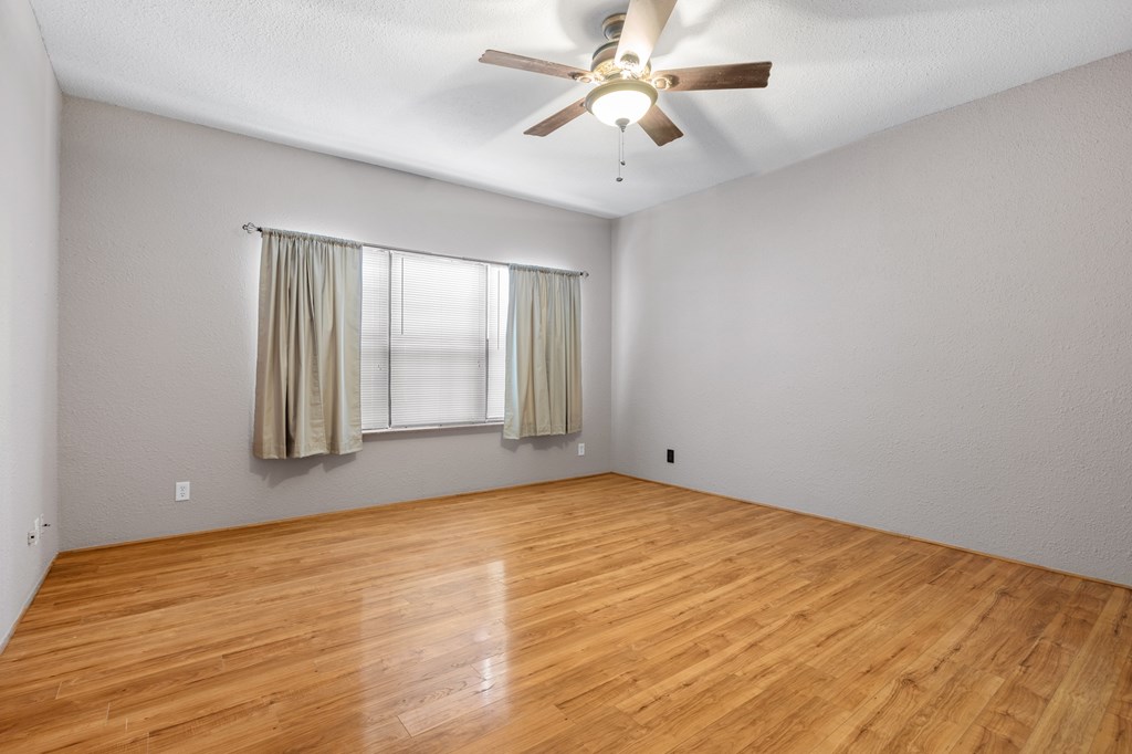 64 Quail Run Harper, TX 78631 - Photo 16 of 25 wooden floor in an empty room with a window
