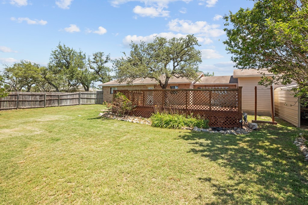 64 Quail Run Harper, TX 78631 - Photo 2 of 25 a view of a swimming pool with a patio and a yard