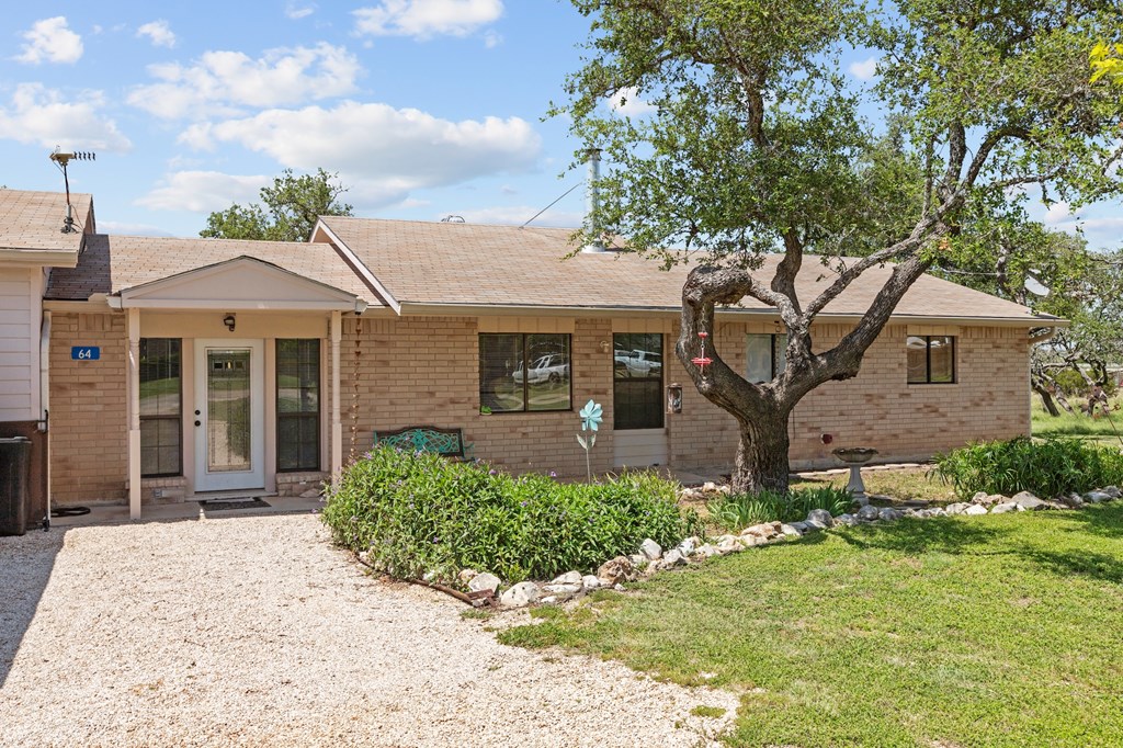 64 Quail Run Harper, TX 78631 - Photo 23 of 25 a front view of a house with a garden