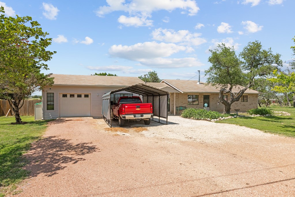 64 Quail Run Harper, TX 78631 - Photo 24 of 25 a view of a house with a yard