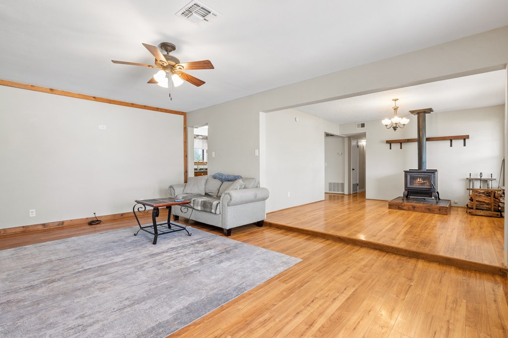 64 Quail Run Harper, TX 78631 - Photo 5 of 25 a bedroom with a bed and wooden floor