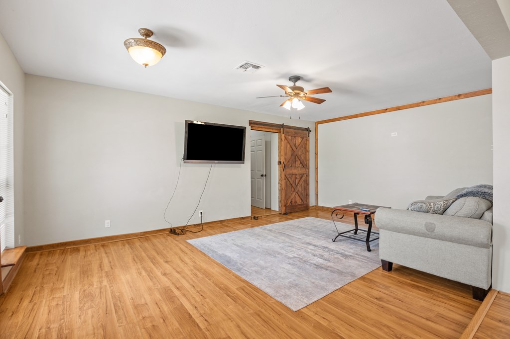 64 Quail Run Harper, TX 78631 - Photo 8 of 25 a living room with a flat screen tv and a couch