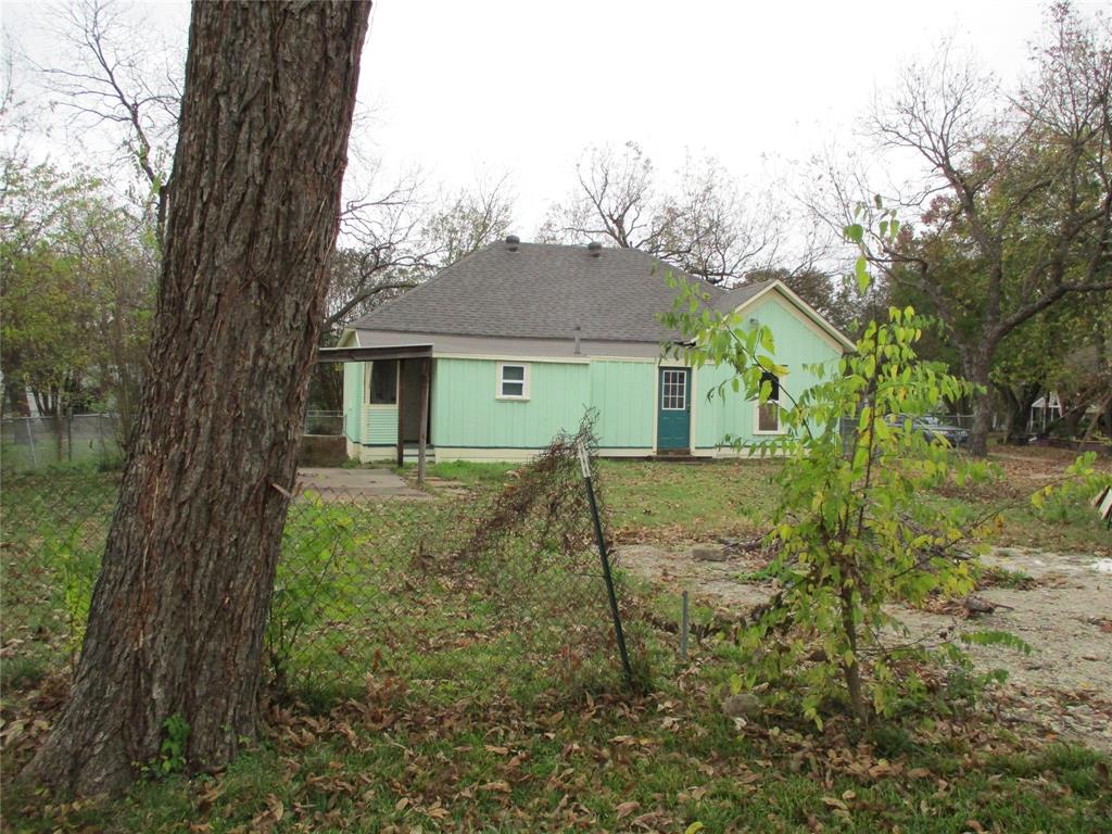 a view of a house with a tree in the yard
