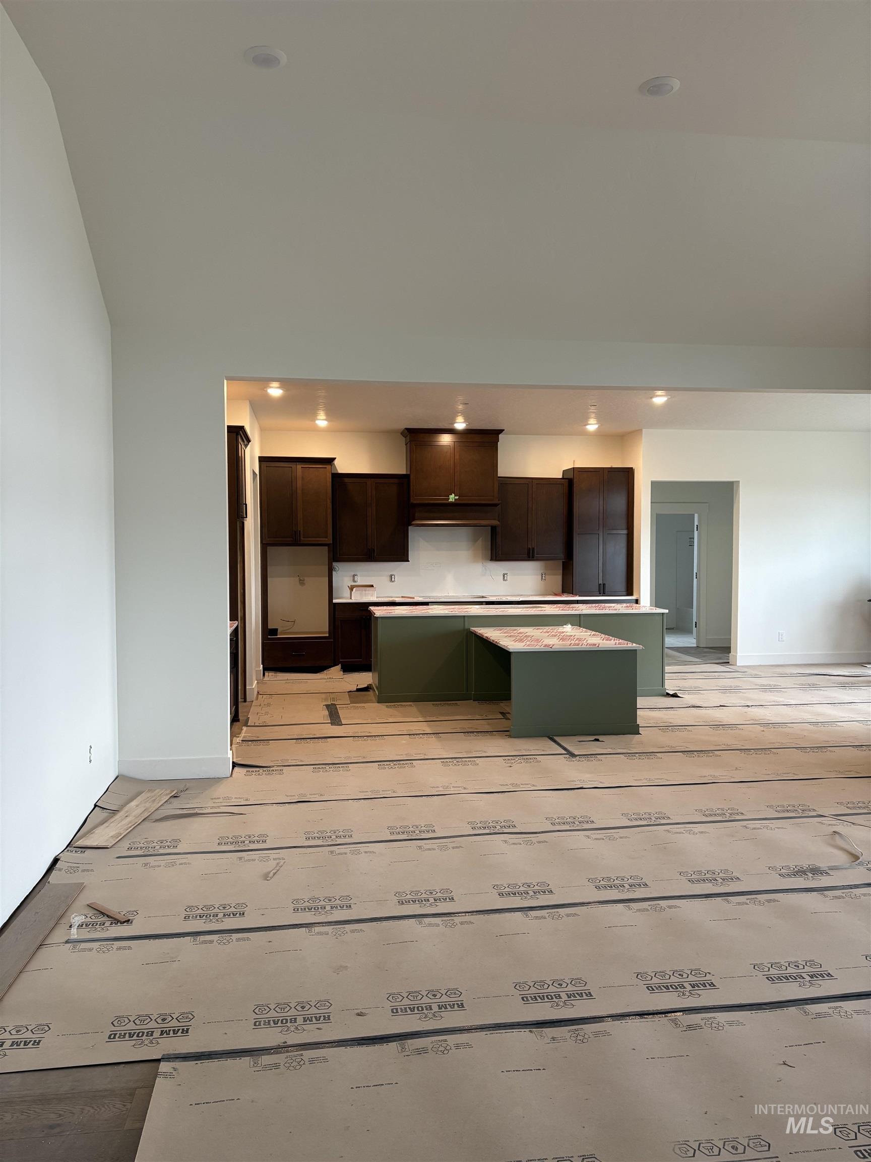 6431 Raptor Ridge Lane Melba, ID 83641 - Photo 10 of 12 Kitchen featuring a center island, light countertops, green cabinetry, recessed lighting, and dark brown cabinetry