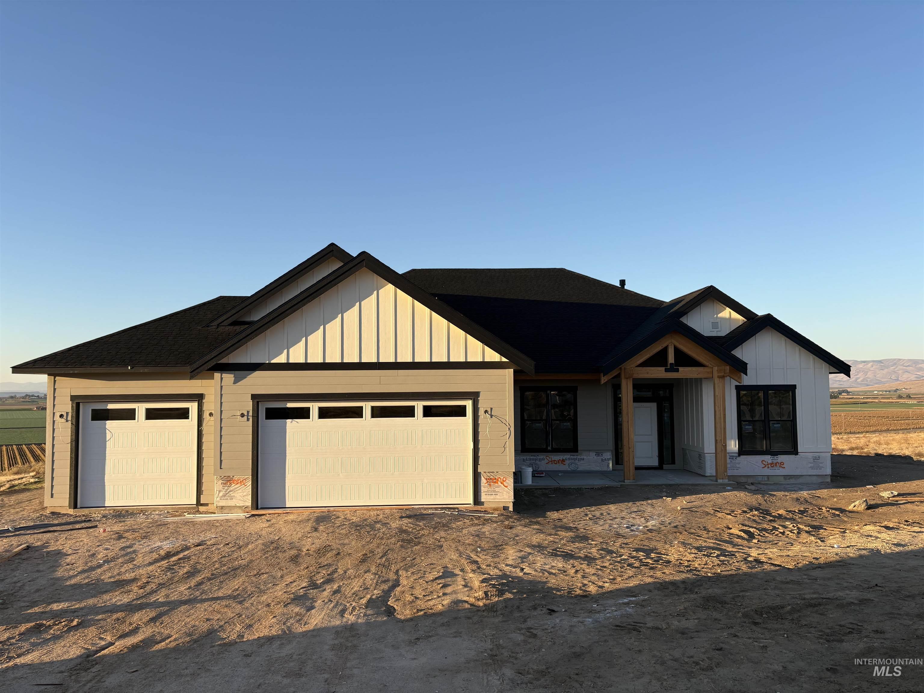 6431 Raptor Ridge Lane Melba, ID 83641 - Photo 2 of 5 Modern farmhouse style home with board and batten siding, driveway, and an attached garage