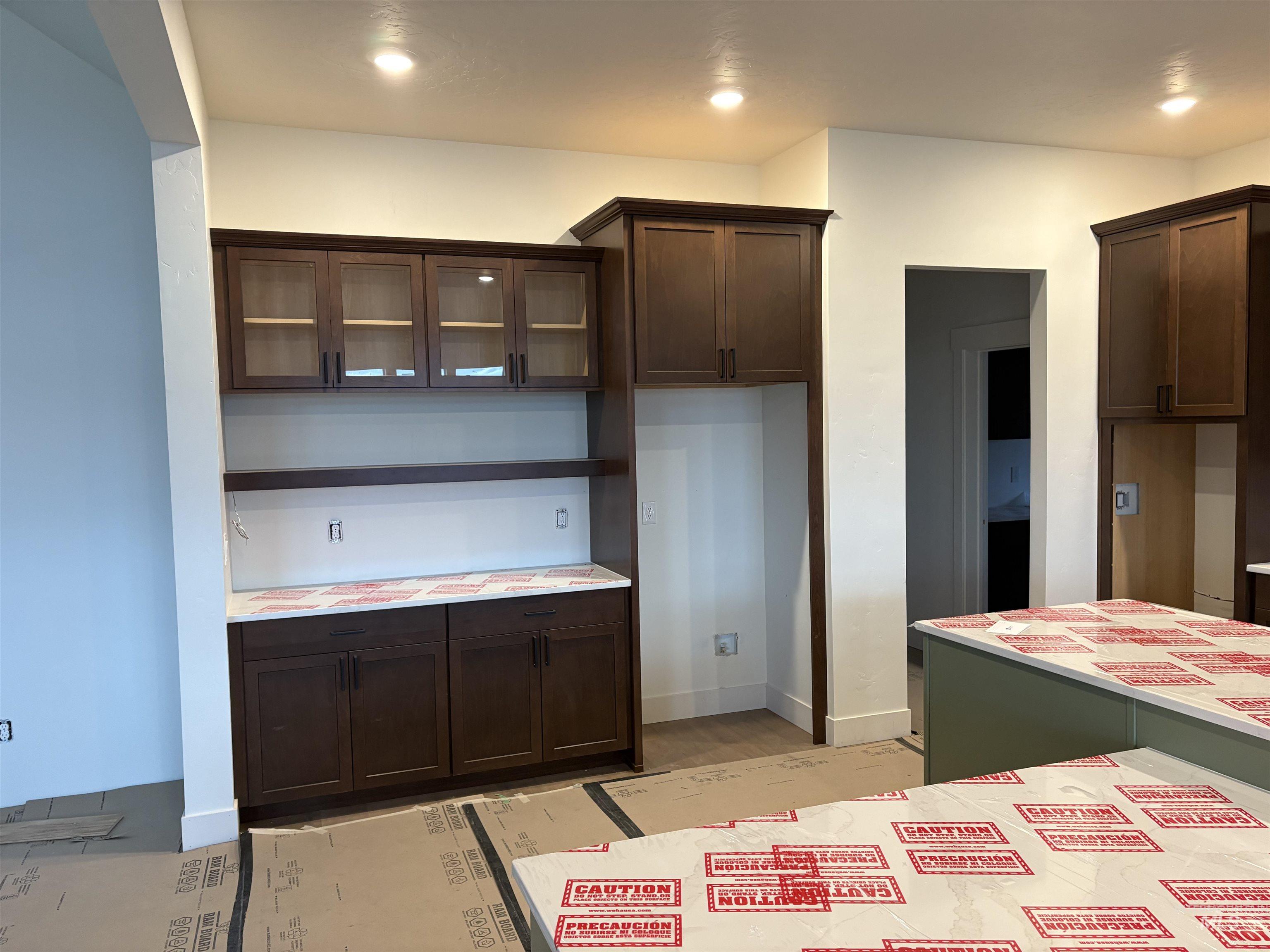 6431 Raptor Ridge Lane Melba, ID 83641 - Photo 5 of 12 Kitchen with glass insert cabinets, dark brown cabinets, and open shelves