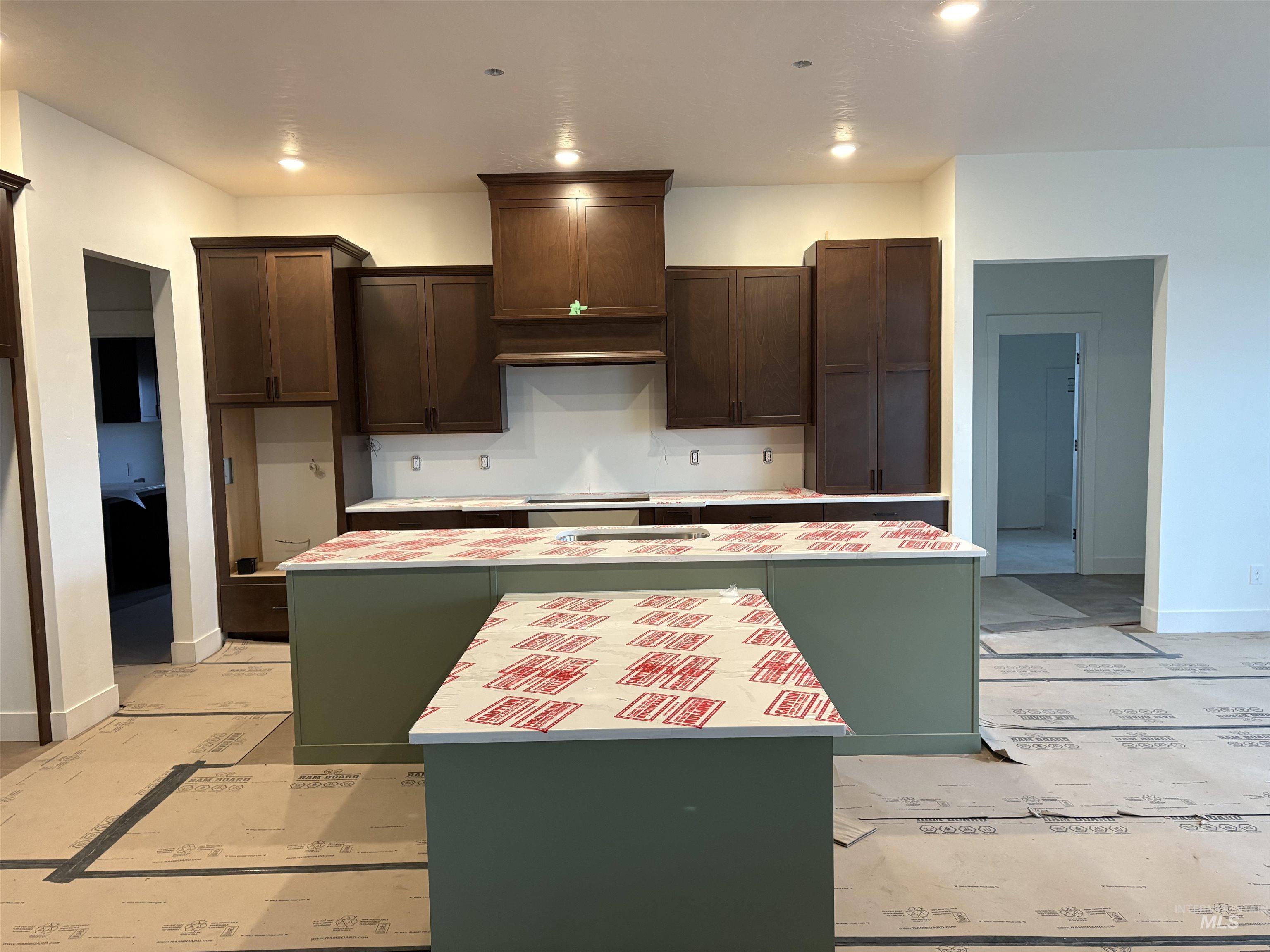 6431 Raptor Ridge Lane Melba, ID 83641 - Photo 6 of 12 Kitchen featuring a center island, dark brown cabinets, light countertops, and recessed lighting