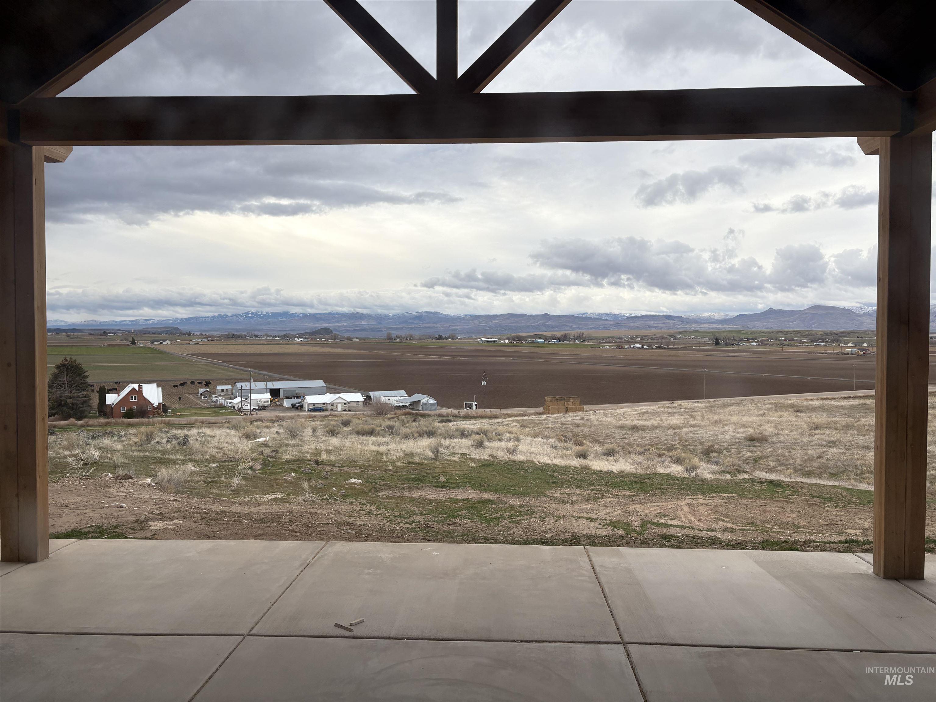 6431 Raptor Ridge Lane Melba, ID 83641 - Photo 8 of 12 View of yard with a mountain view and a patio