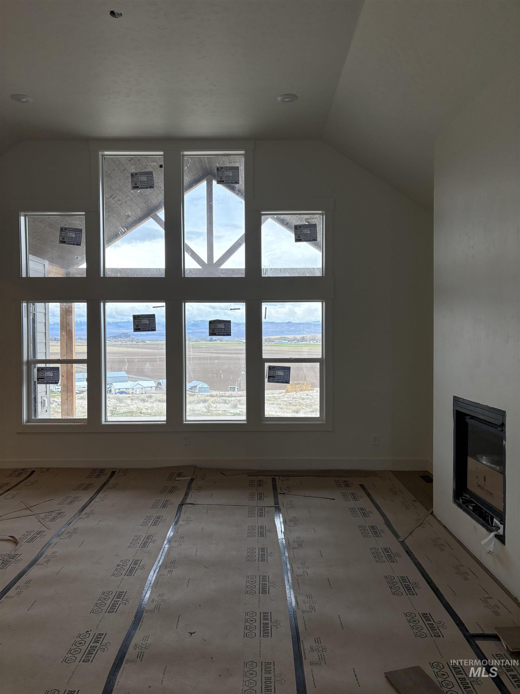 6431 Raptor Ridge Lane Melba, ID 83641 - Photo 9 of 12 Additional living space featuring a fireplace and lofted ceiling