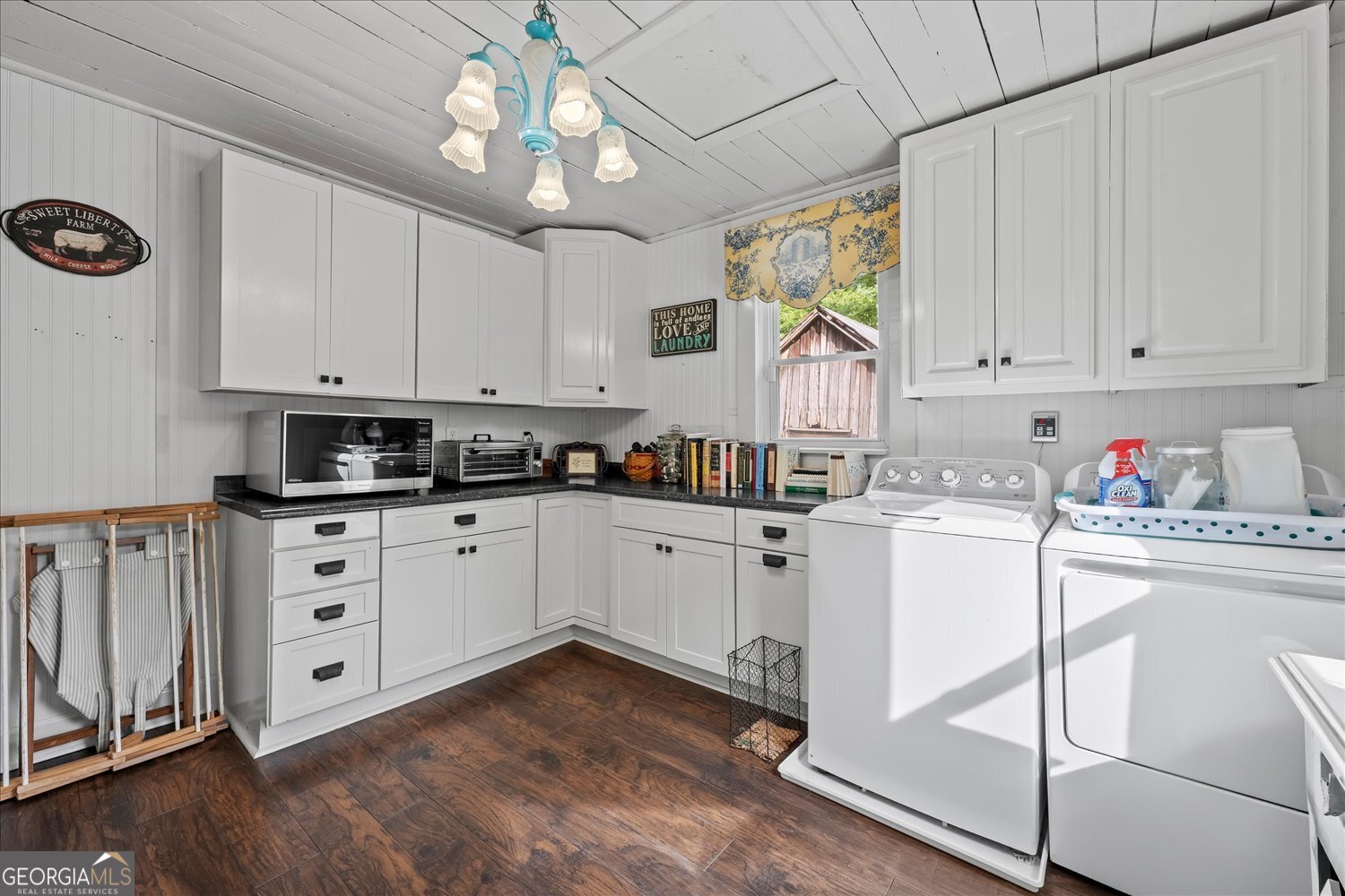 6644 East Cadley Road Norwood, GA 30821 - Photo 27 of 53 a kitchen with granite countertop white cabinets white appliances a sink and a window