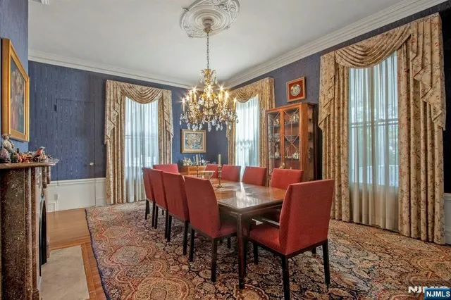 a dining room with furniture a chandelier and wooden floor