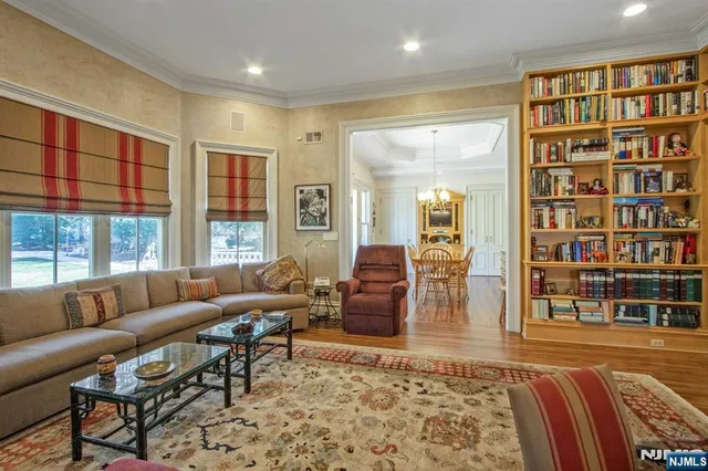 a living room with furniture and a book shelf