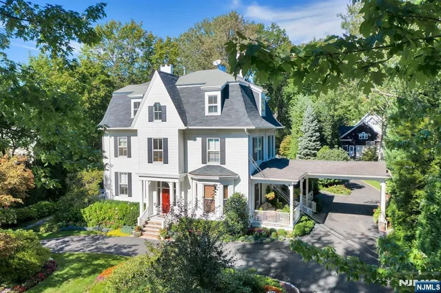 a aerial view of a house with a yard and potted plants