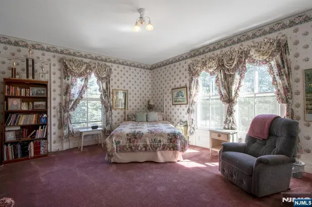 a spacious bedroom with a bed and a large window