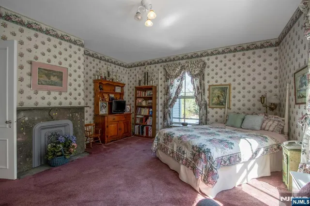 a bedroom with a bed and a fireplace