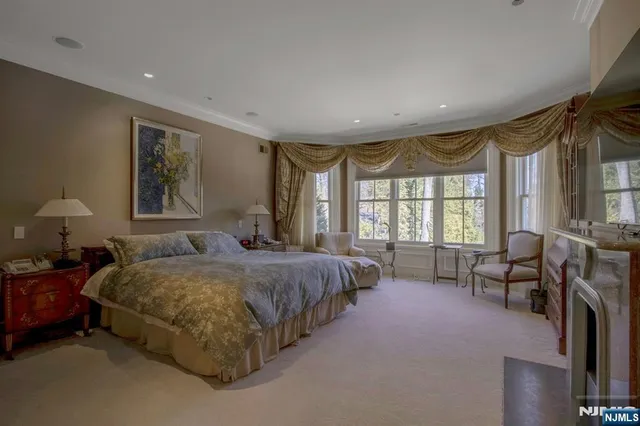 a spacious bedroom with a bed and a large window