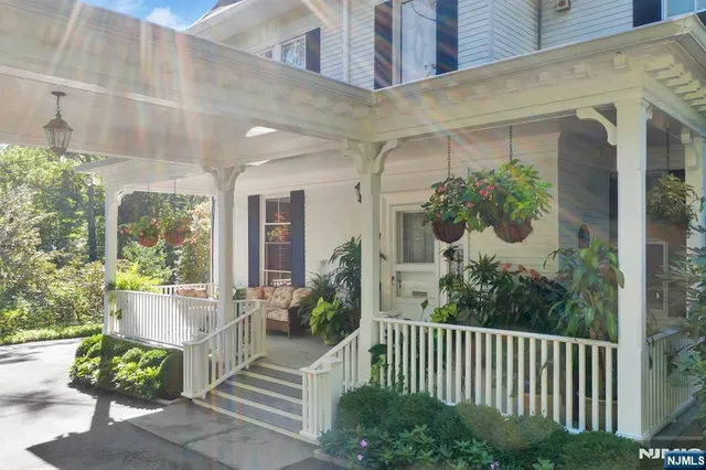 a view of a house with a porch and furniture