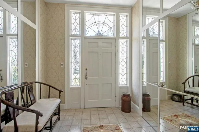a view of a hallway with furniture and front door