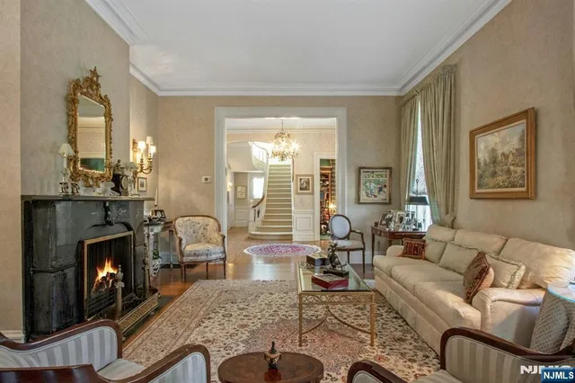a living room with furniture large window and a fireplace