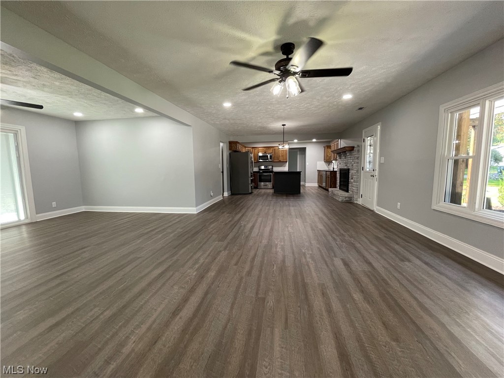 1857 Sterling Road Madison, OH 44057 - Photo 10 of 33 Living room with light hardwood flooring, a textured ceiling, and ceiling fan
