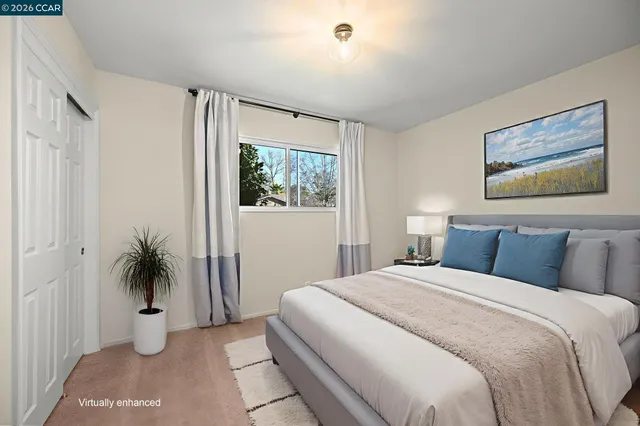 a bedroom with a large bed and a potted plant