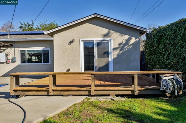 a view of house with backyard and pool