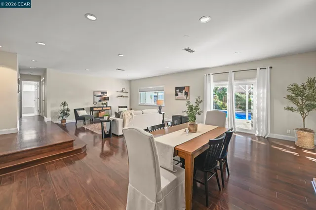 a view of a dining room with furniture and wooden floor