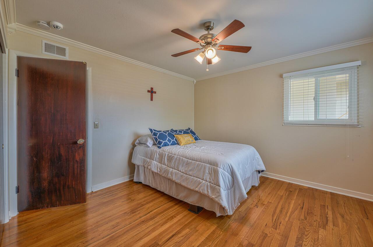918 Junipero Way Salinas, CA 93901 - Photo 17 of 33 a bedroom with a bed and wooden floor