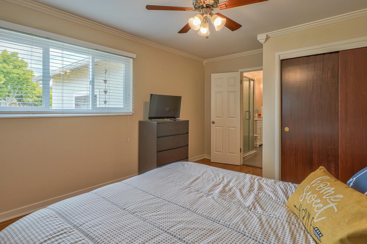 918 Junipero Way Salinas, CA 93901 - Photo 19 of 33 a bedroom with a bed and a chandelier