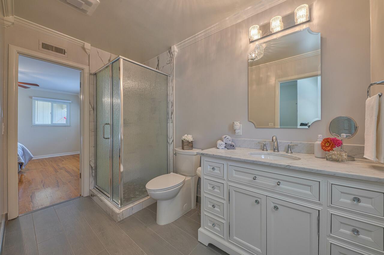 918 Junipero Way Salinas, CA 93901 - Photo 20 of 33 a bathroom with a double vanity sink toilet mirror and shower