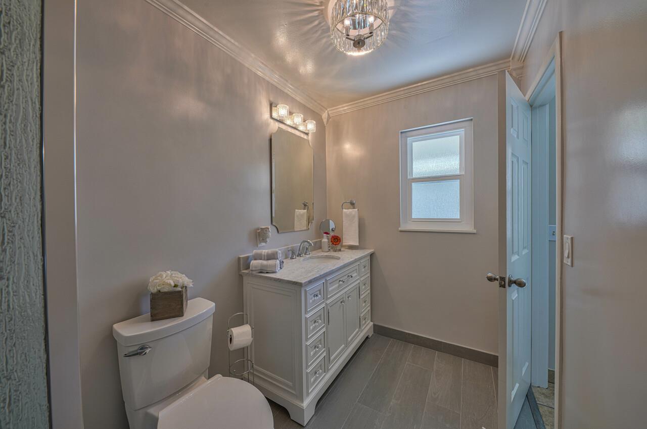 918 Junipero Way Salinas, CA 93901 - Photo 21 of 33 a en suite bathroom with a toilet a sink and mirror