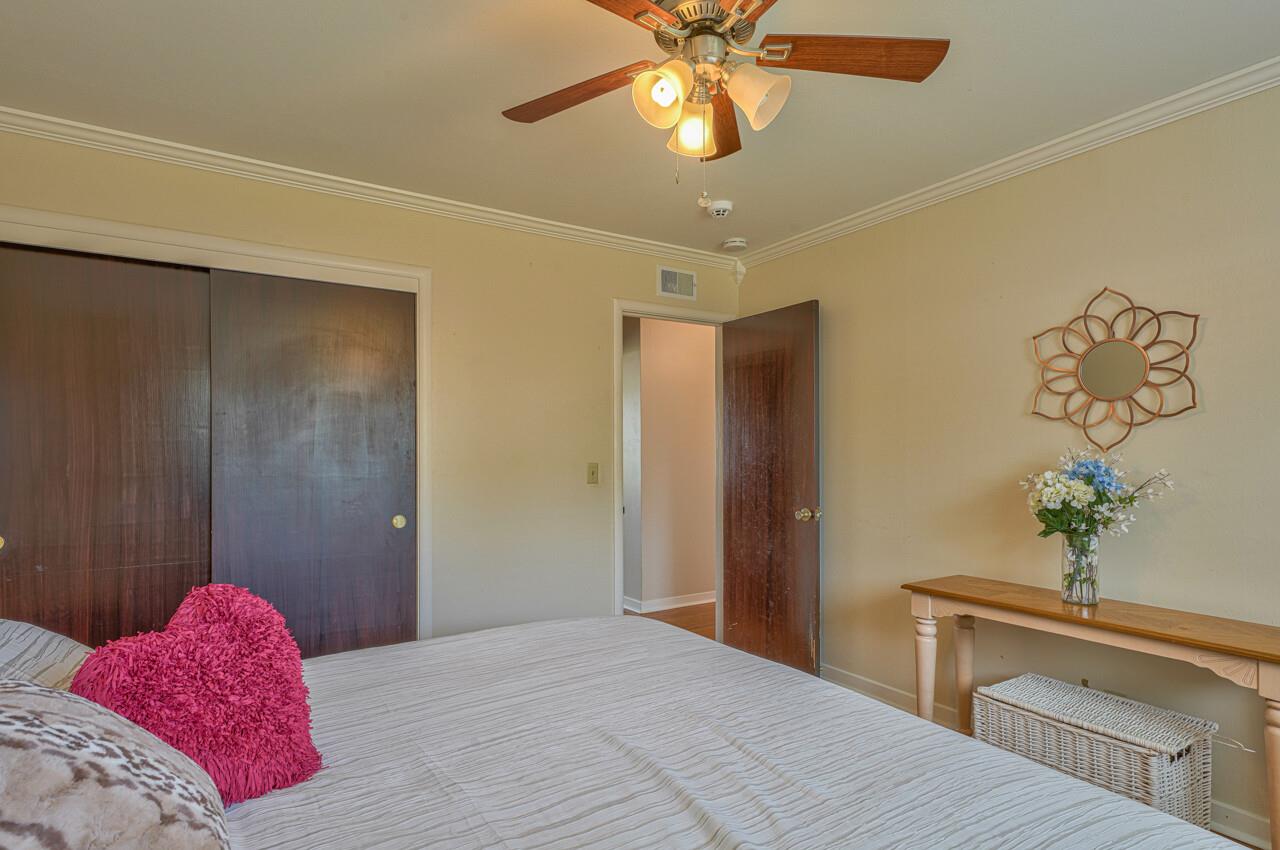 918 Junipero Way Salinas, CA 93901 - Photo 24 of 33 a bedroom with a bed and a chandelier