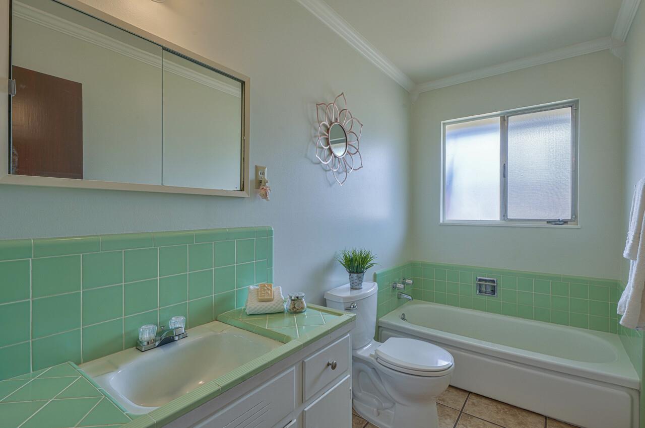 918 Junipero Way Salinas, CA 93901 - Photo 27 of 33 a bathroom with a sink toilet and a mirror