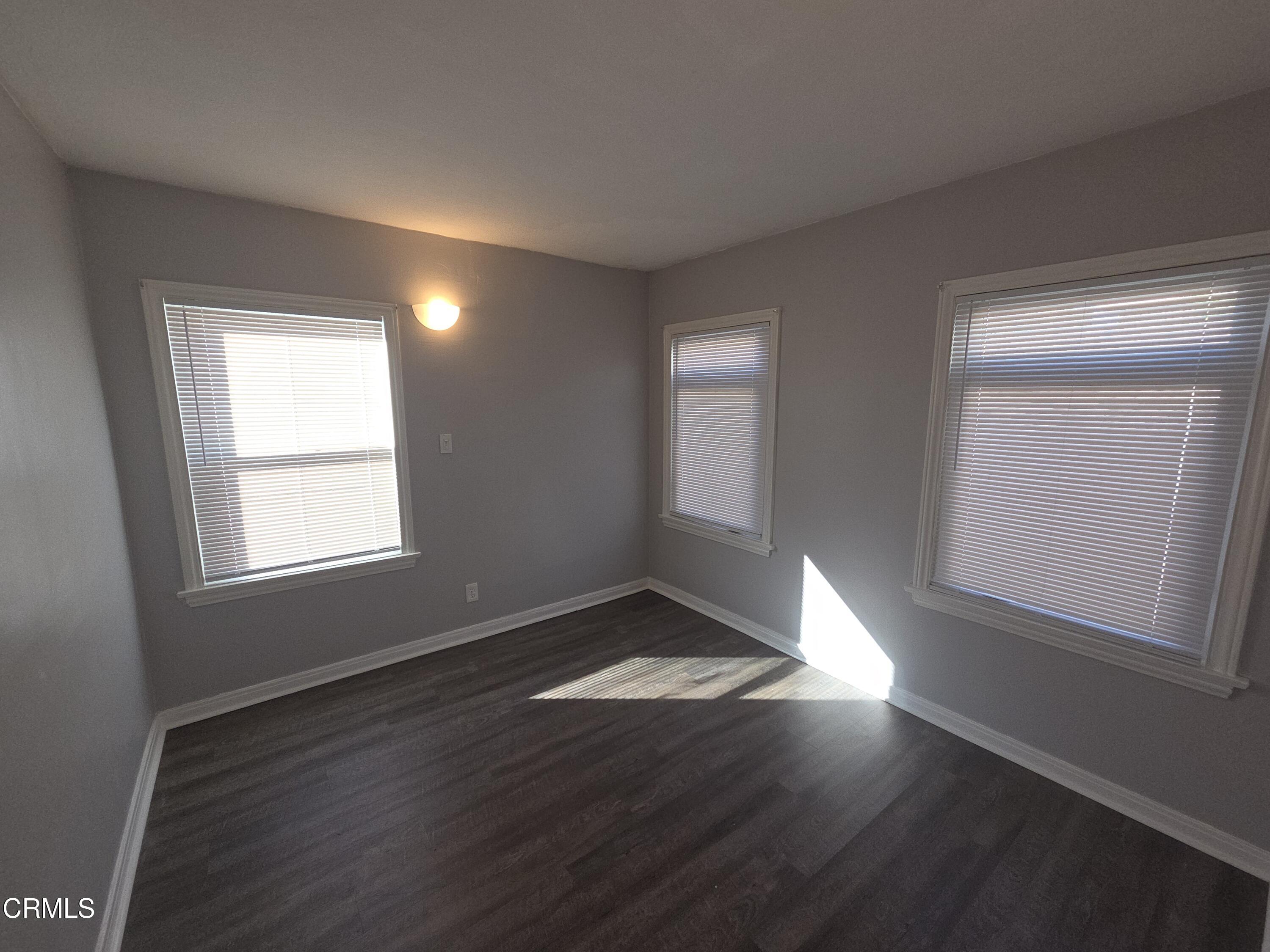 407 South Verdugo Road Glendale, CA 91205 - Photo 12 of 14 an empty room with wooden floor and windows