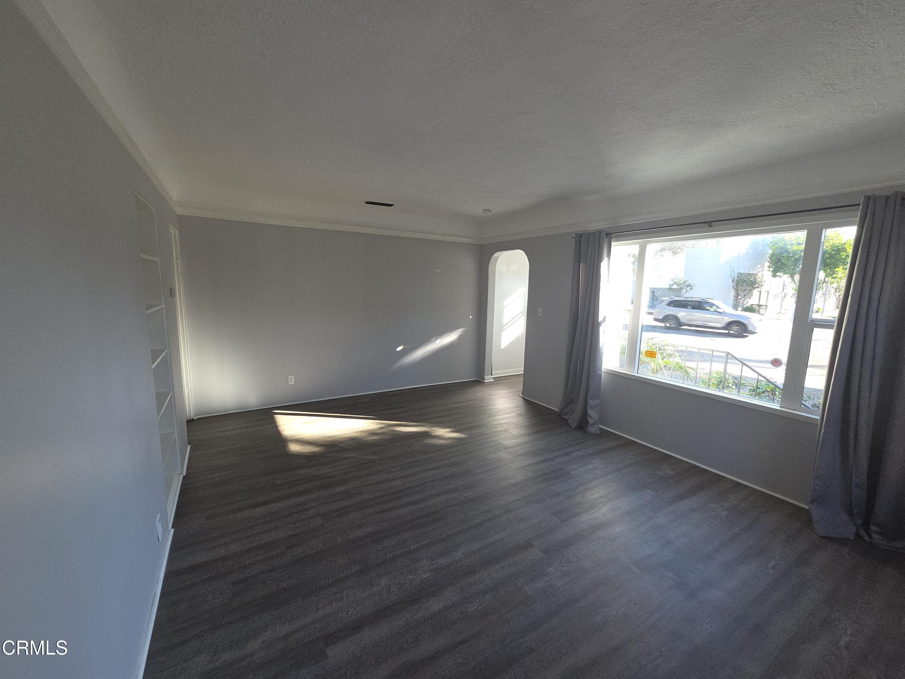 407 South Verdugo Road Glendale, CA 91205 - Photo 4 of 14 an empty room with wooden floor and windows