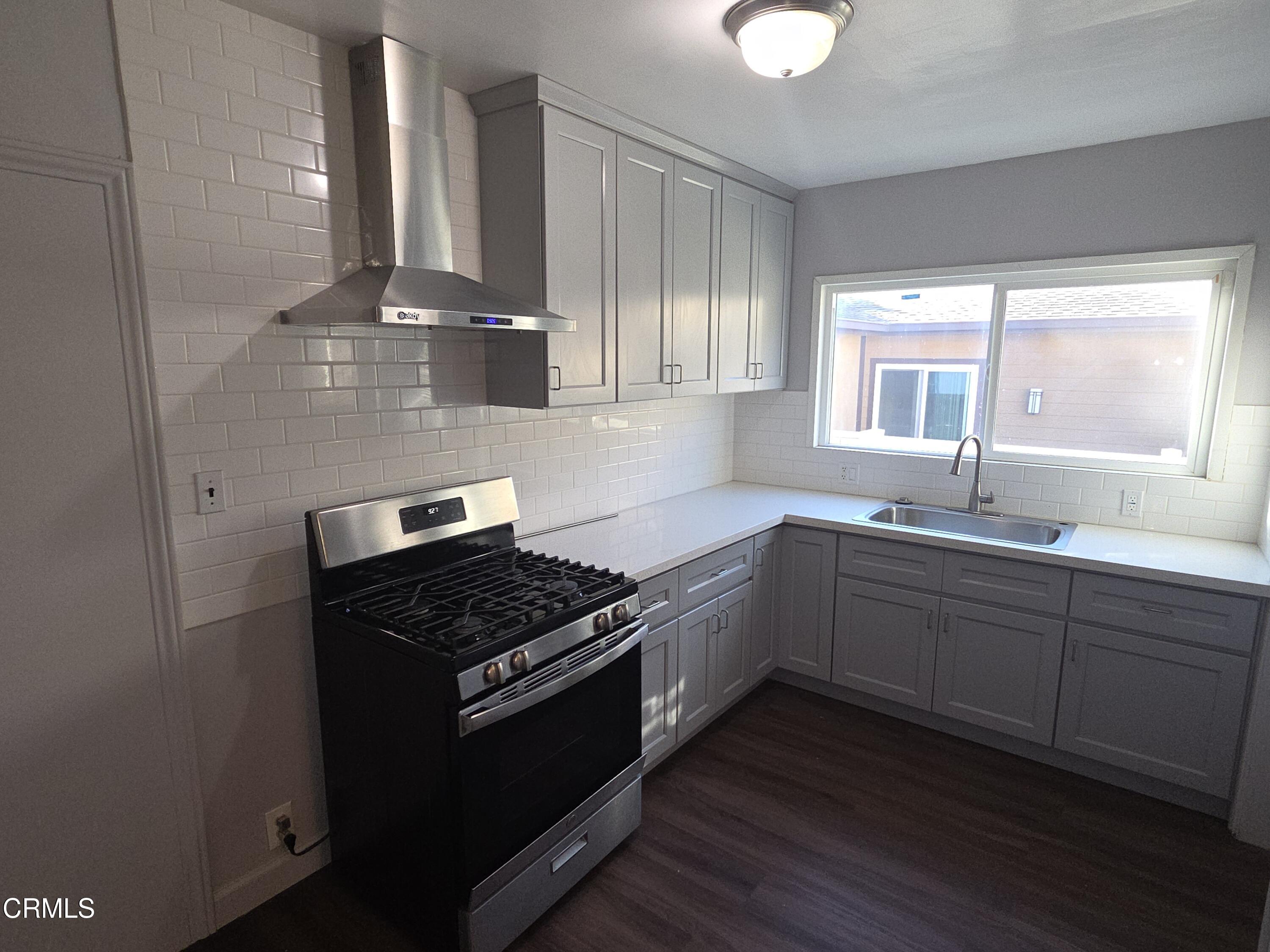 407 South Verdugo Road Glendale, CA 91205 - Photo 5 of 14 a kitchen with stainless steel appliances granite countertop a sink stove and cabinets