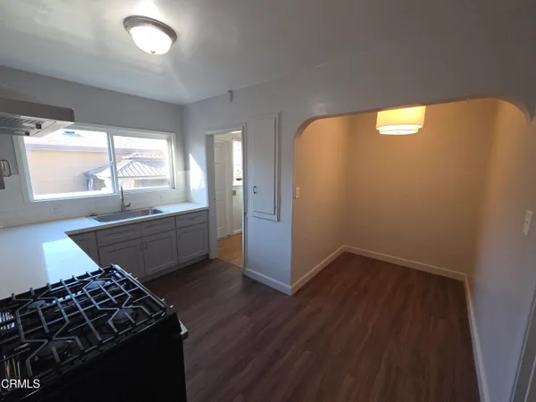 a kitchen with wooden floors and a stove