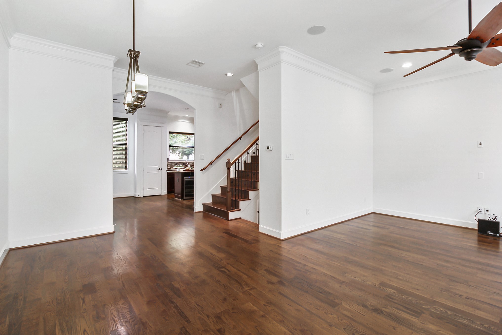 612 West 27th Street Houston, TX 77008 - Photo 24 of 36 a view of a room with wooden floor staircase and a kitchen view