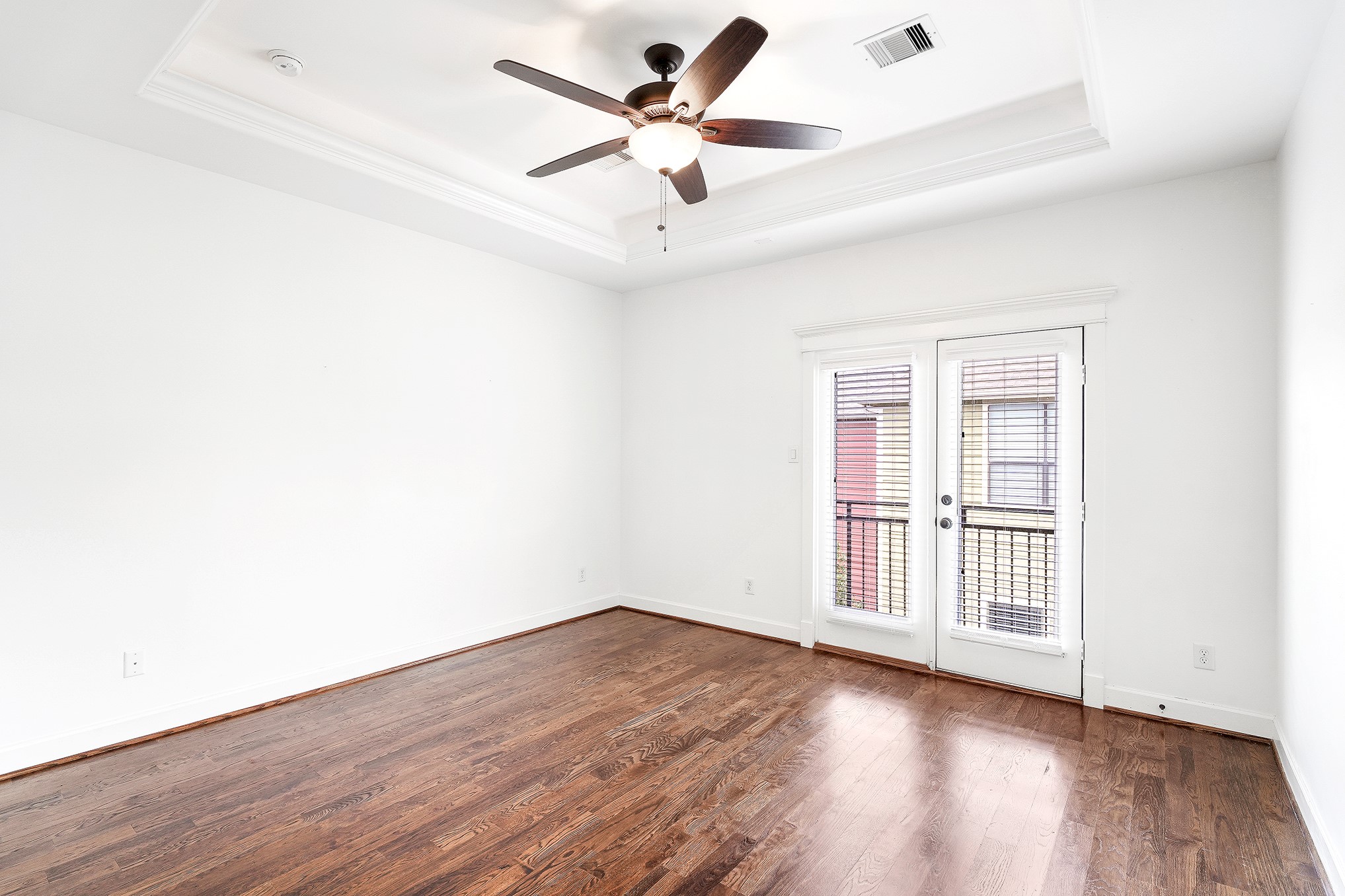 612 West 27th Street Houston, TX 77008 - Photo 26 of 36 an empty room with wooden floor and ceiling fan