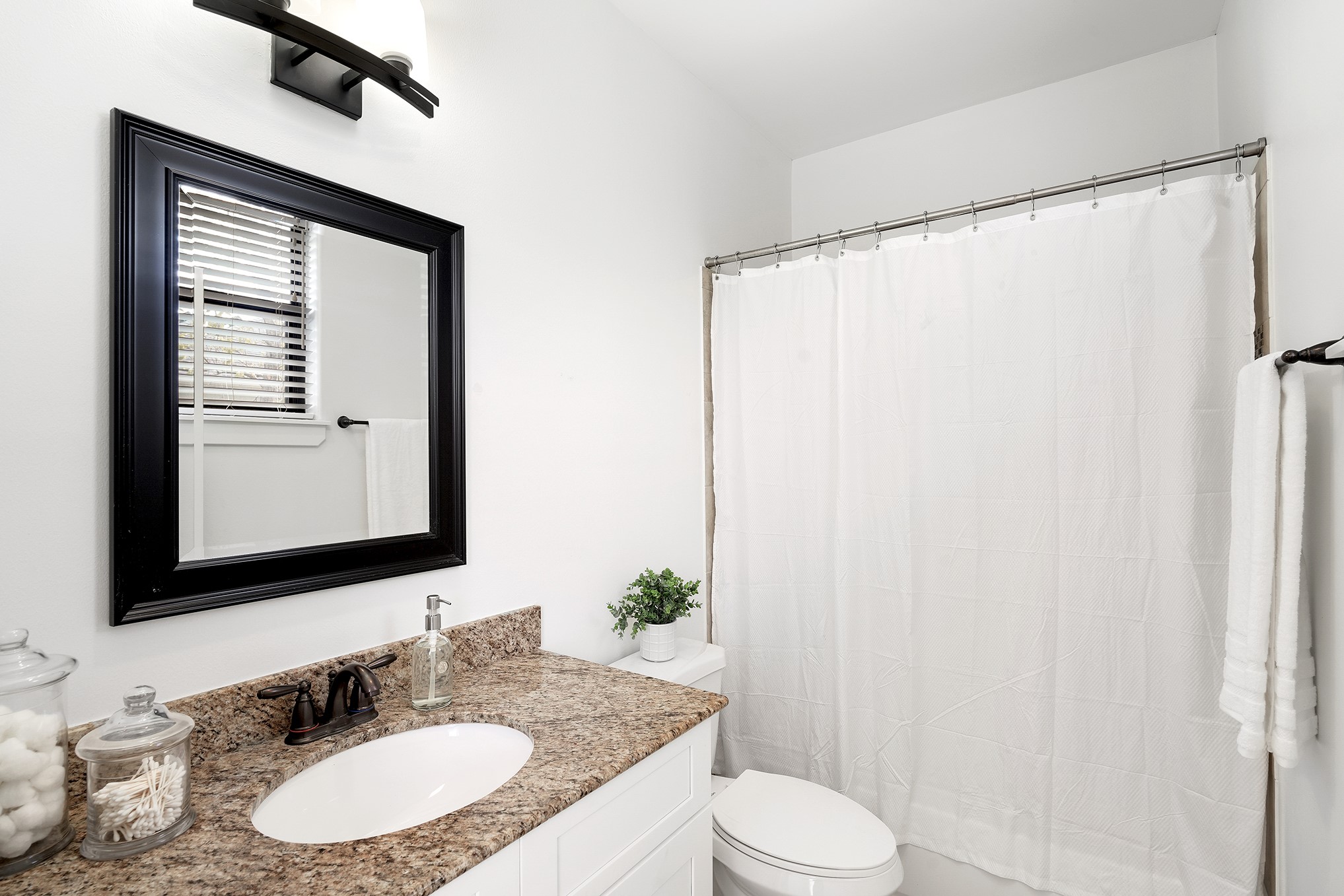 612 West 27th Street Houston, TX 77008 - Photo 34 of 36 a bathroom with a granite countertop sink toilet and mirror