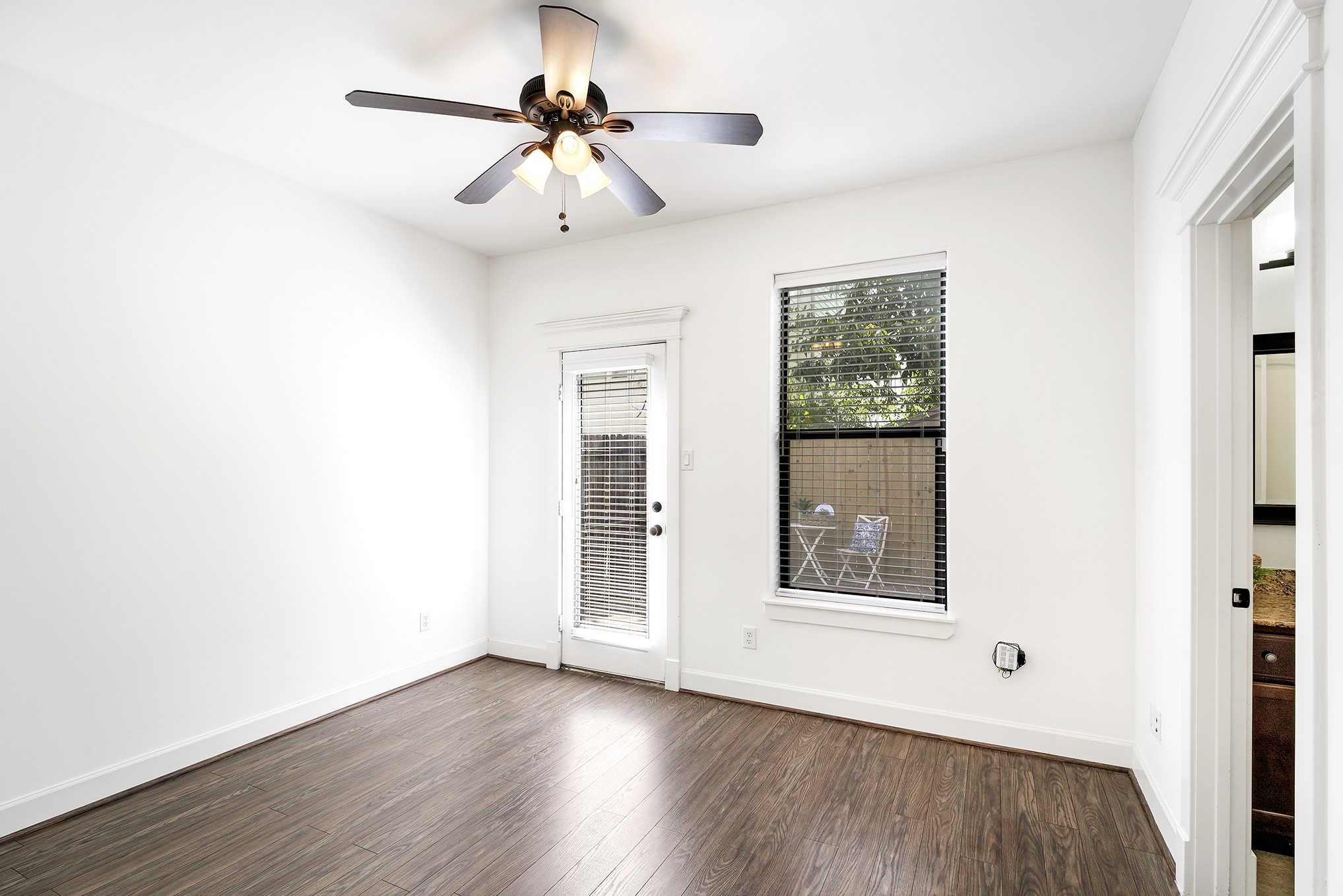 612 West 27th Street Houston, TX 77008 - Photo 7 of 36 a view of an empty room with a window and wooden floor