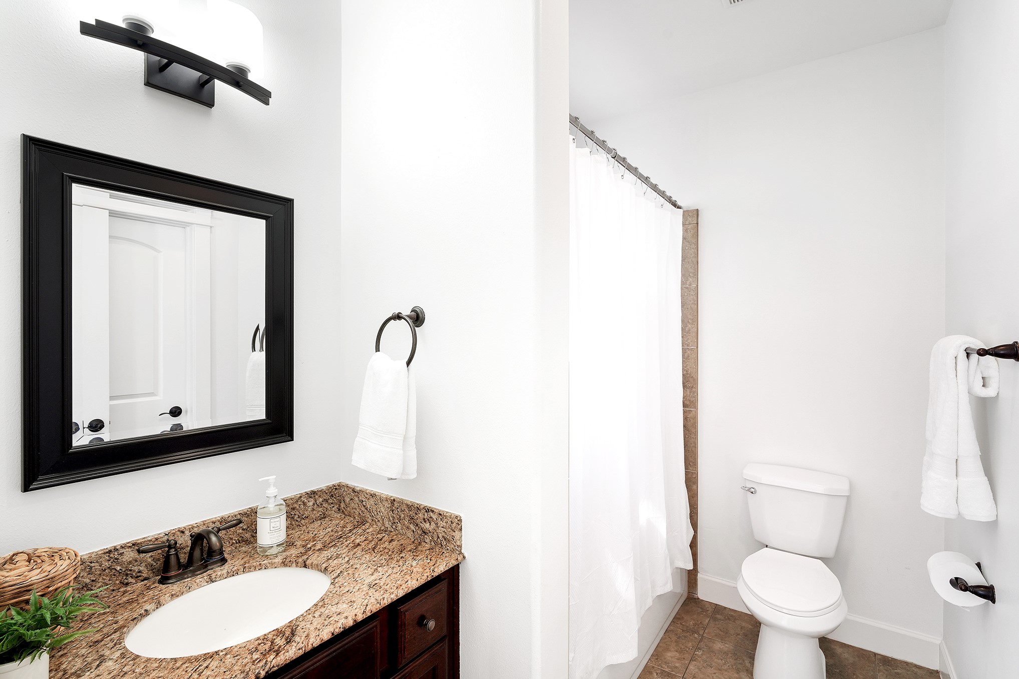 612 West 27th Street Houston, TX 77008 - Photo 8 of 36 a bathroom with a granite countertop sink toilet and mirror