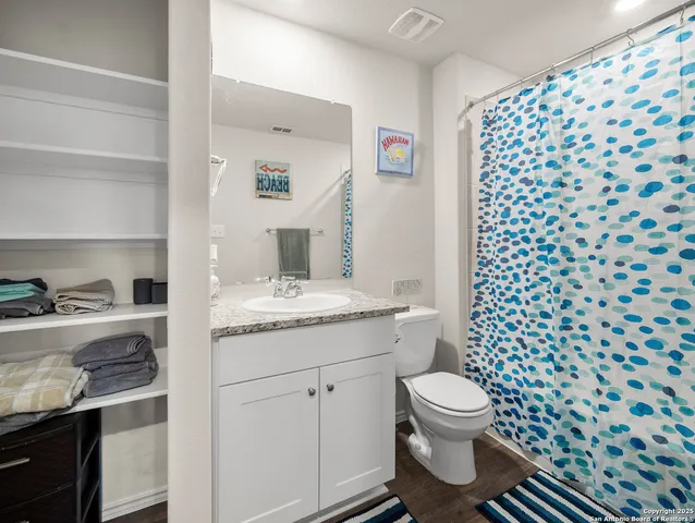 a bathroom with a sink toilet and a mirror