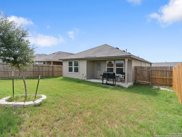 a view of a house with backyard porch and sitting area