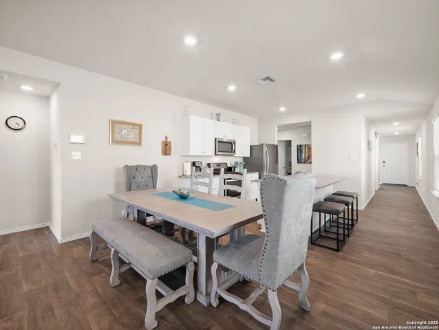 a view of a dining room with furniture and wooden floor